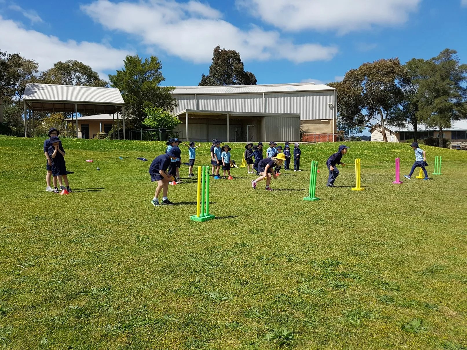 Children playing a cricket game on the oval