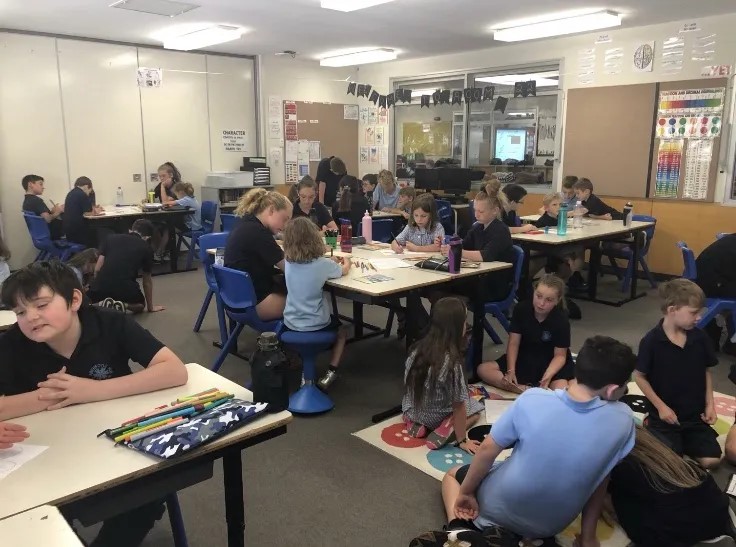 wide view of classroom full of students working with their buddies