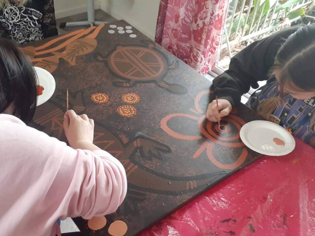 Aboriginal Studies students create a mural at Marra Dreaming Cultural Community Centre